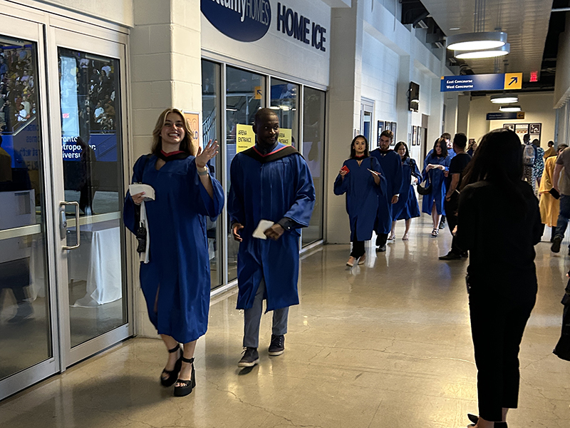 School of Journalism 2023 graduates walk into the convocation ceremony.