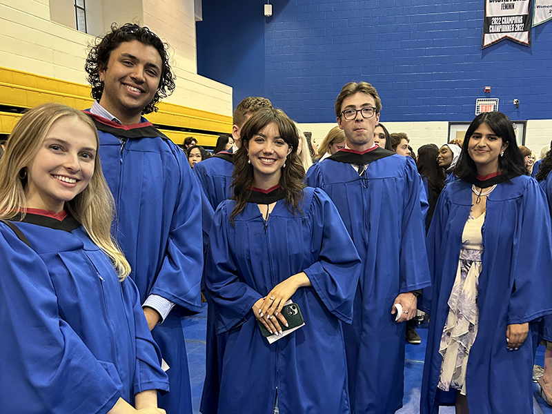 A group of School of Journalism 2023 graduates stand together before the convocation ceremony.