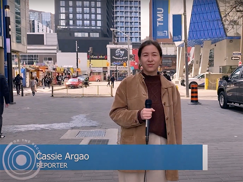 Screengrab of Cassie Argao reporting outside the Student Centre on TMU campus from On The Record. 