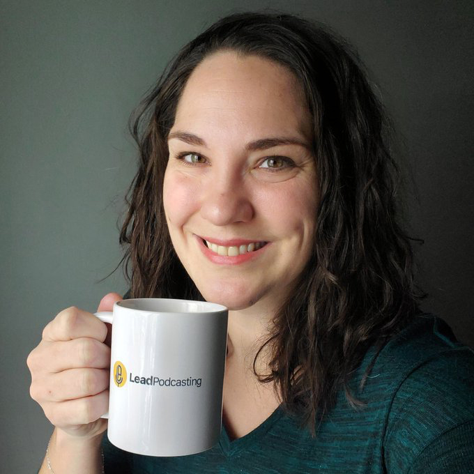 Amanda Cupido holds a mug with "Lead Podcasting," written on it.
