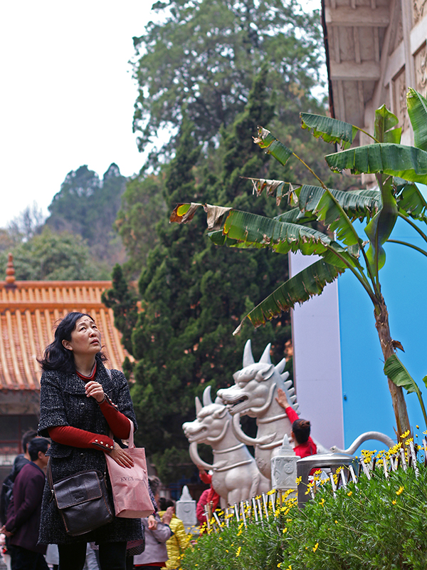 A woman walks by a Buddhist temple in Dali, China. (2018)