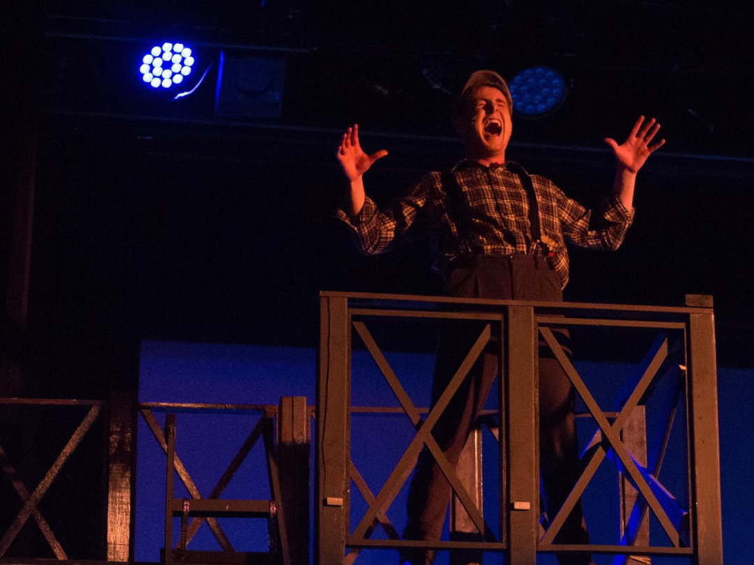 Student singing as part of a musical production. 