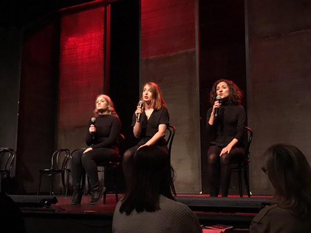 Three women doing stand up. 