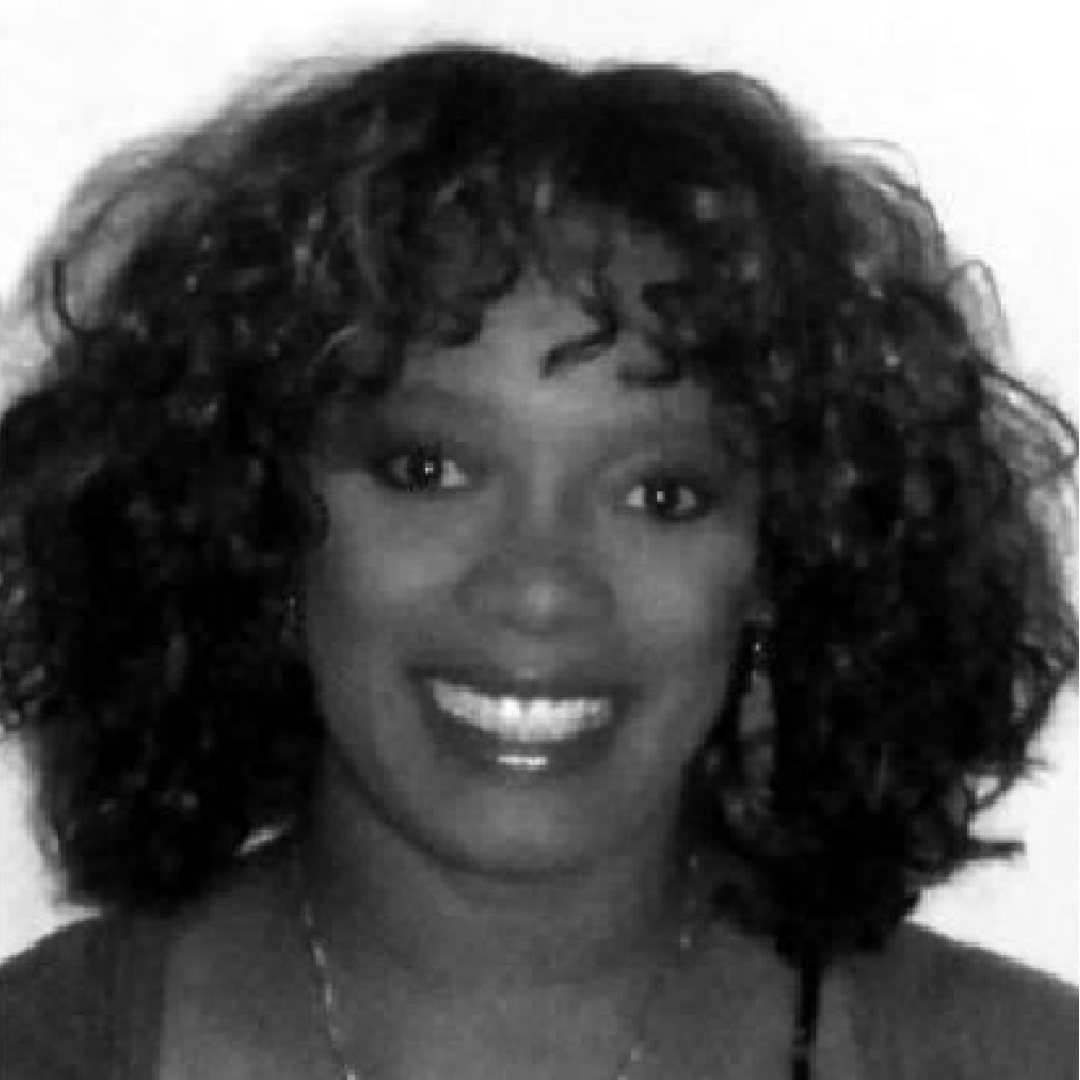 Grey scale headshot of Paula Lateng-Loblack smiling at the camera