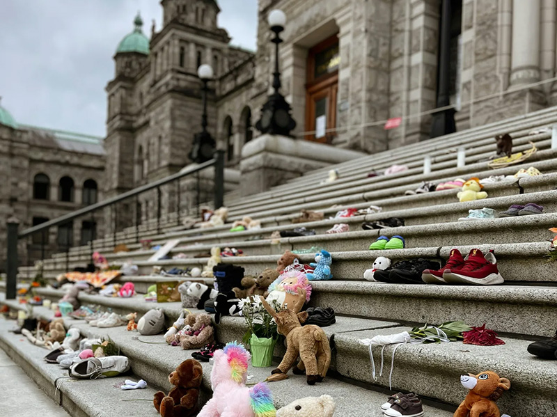 Childrens shoes and toys placed on the steps of a government building