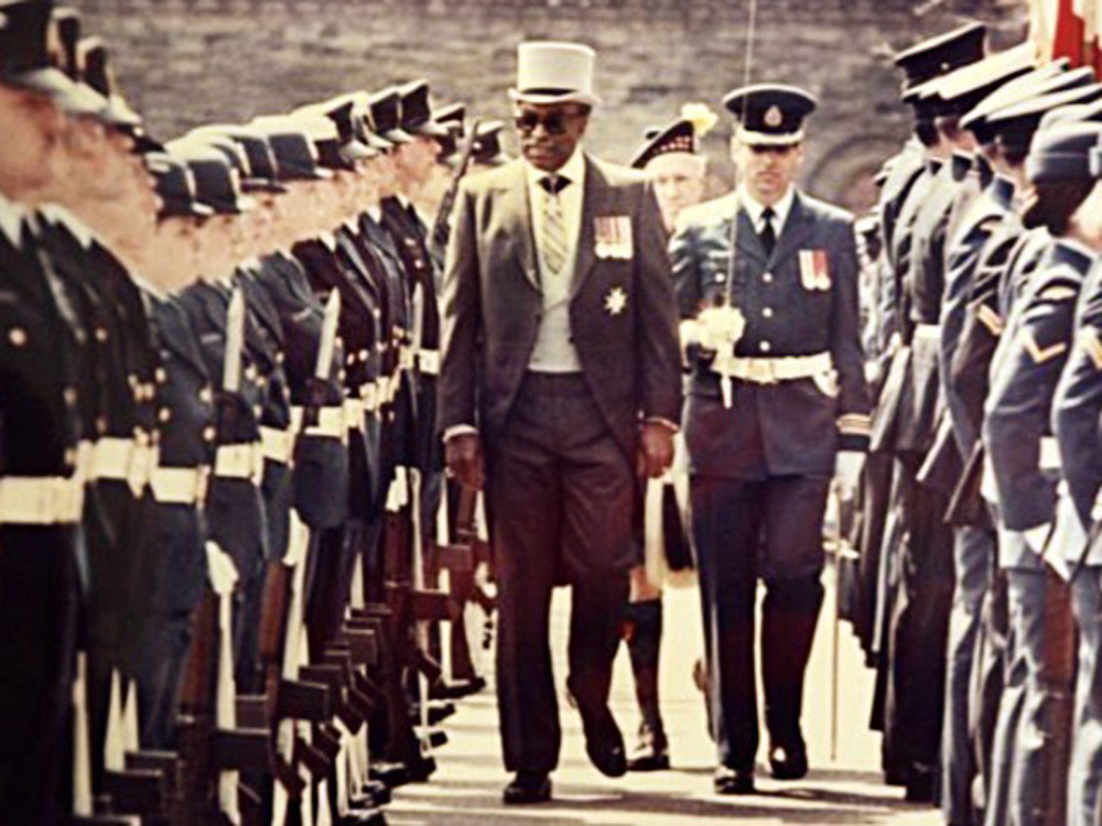 The Honourable Lincoln Alexander marching with military