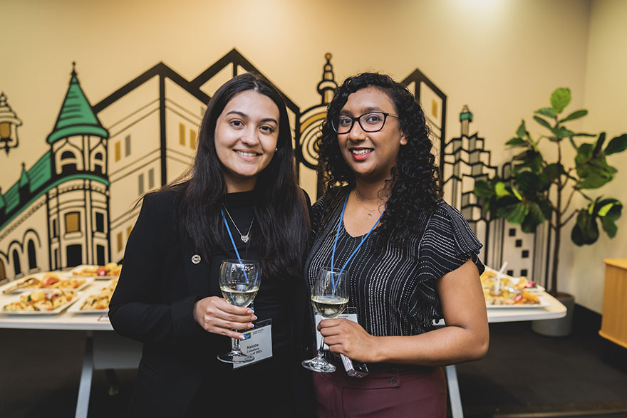 two woman smiling at camera during awards ceremony
