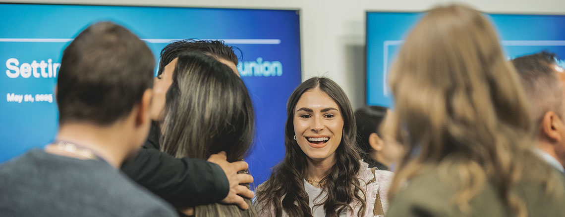 woman smiling at camera in a crowd at awards celebration