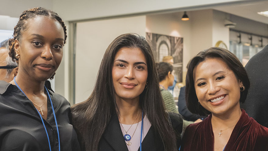 3 women smiling an posing for camera at awards ceremony