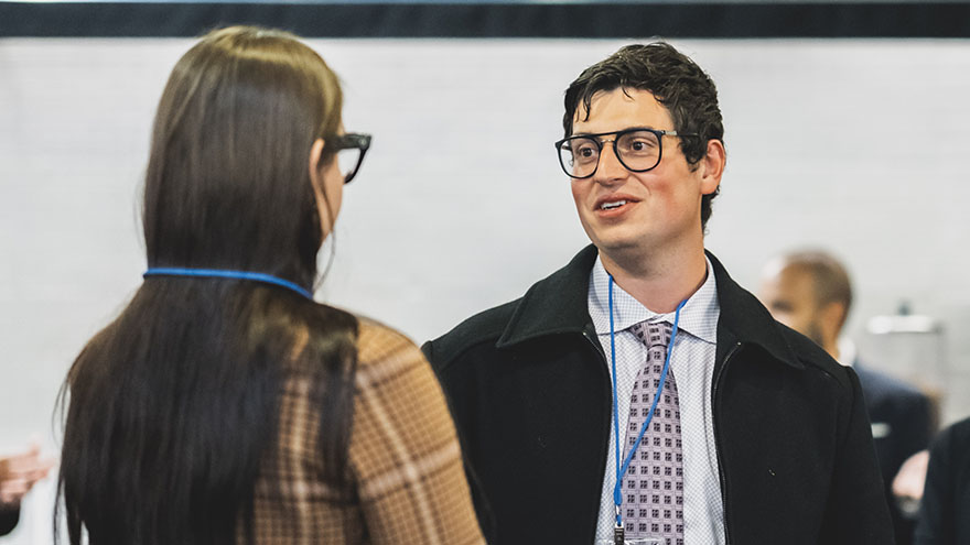 man talking to woman at awards celebration