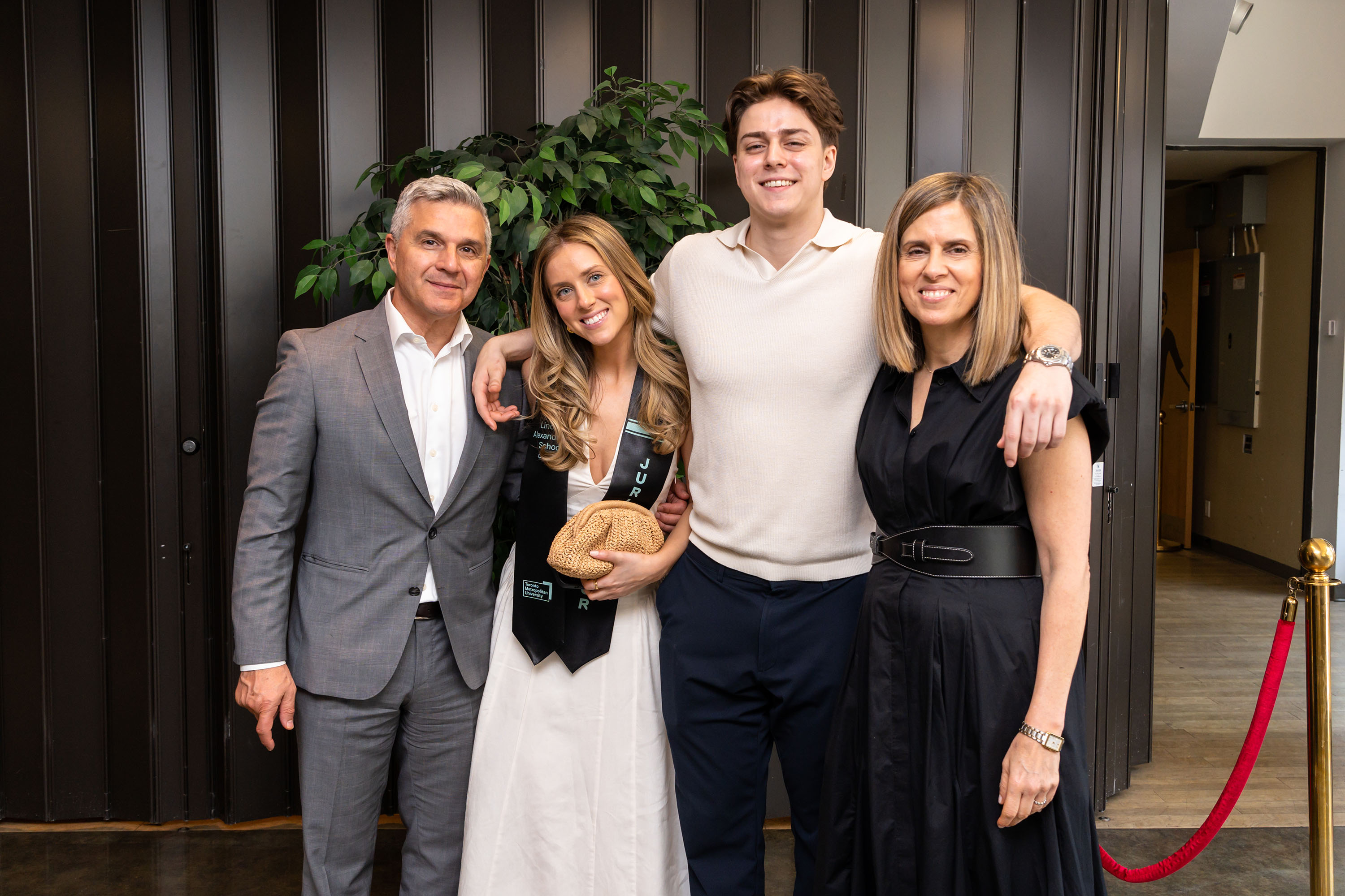 grad and family pose for photo