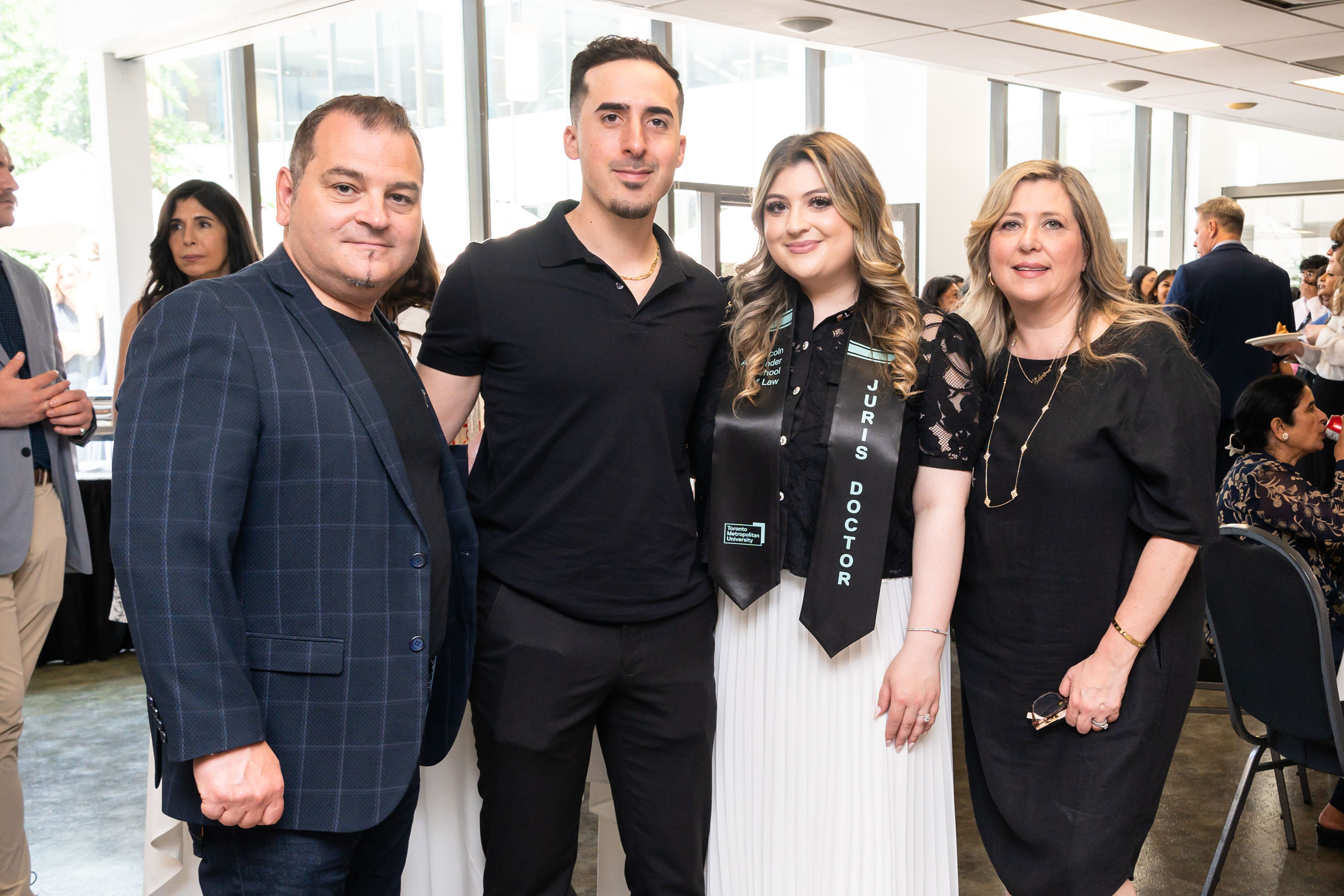 grad and family pose for a photo