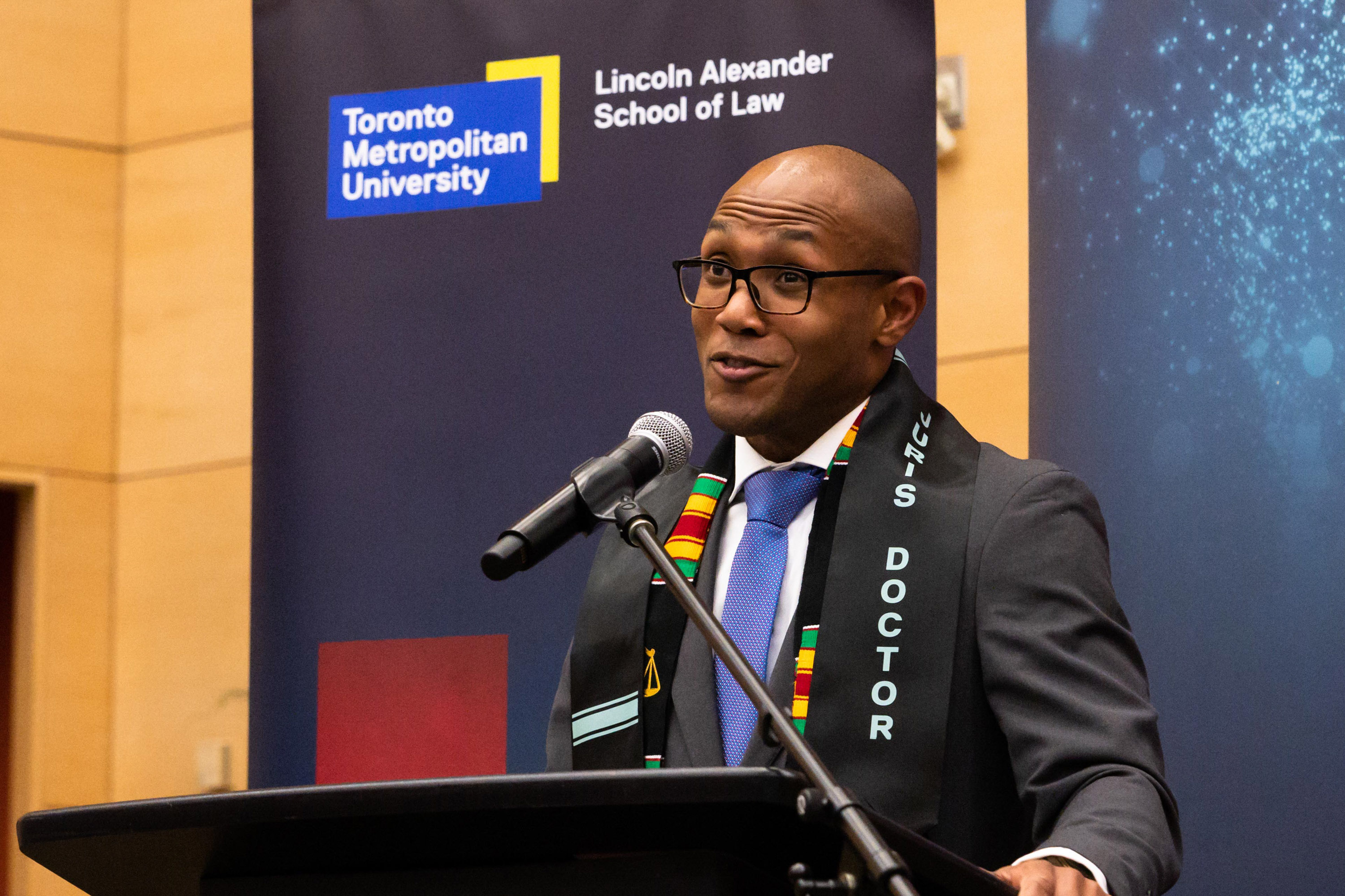 male speaker at the podium during the celebration