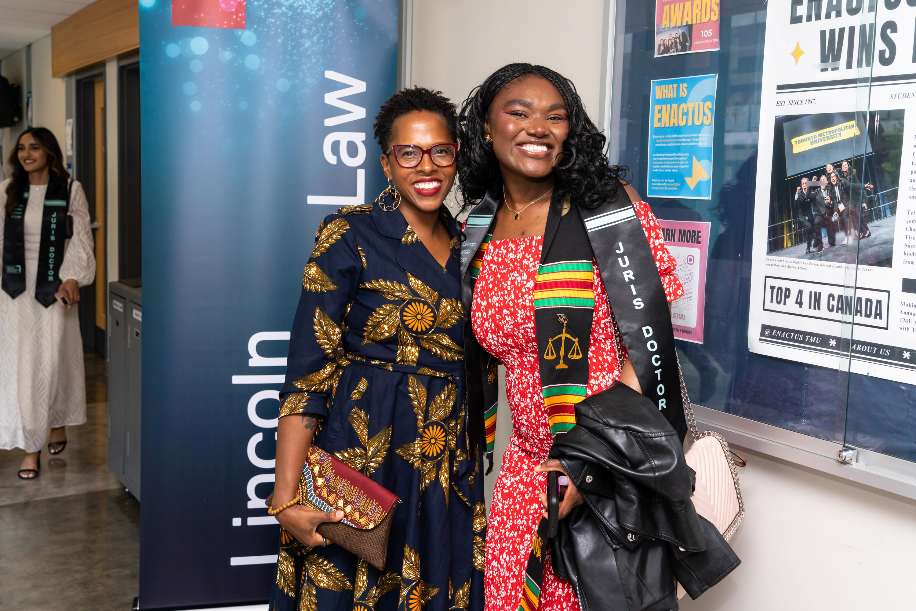 two women posing at the grad celebration