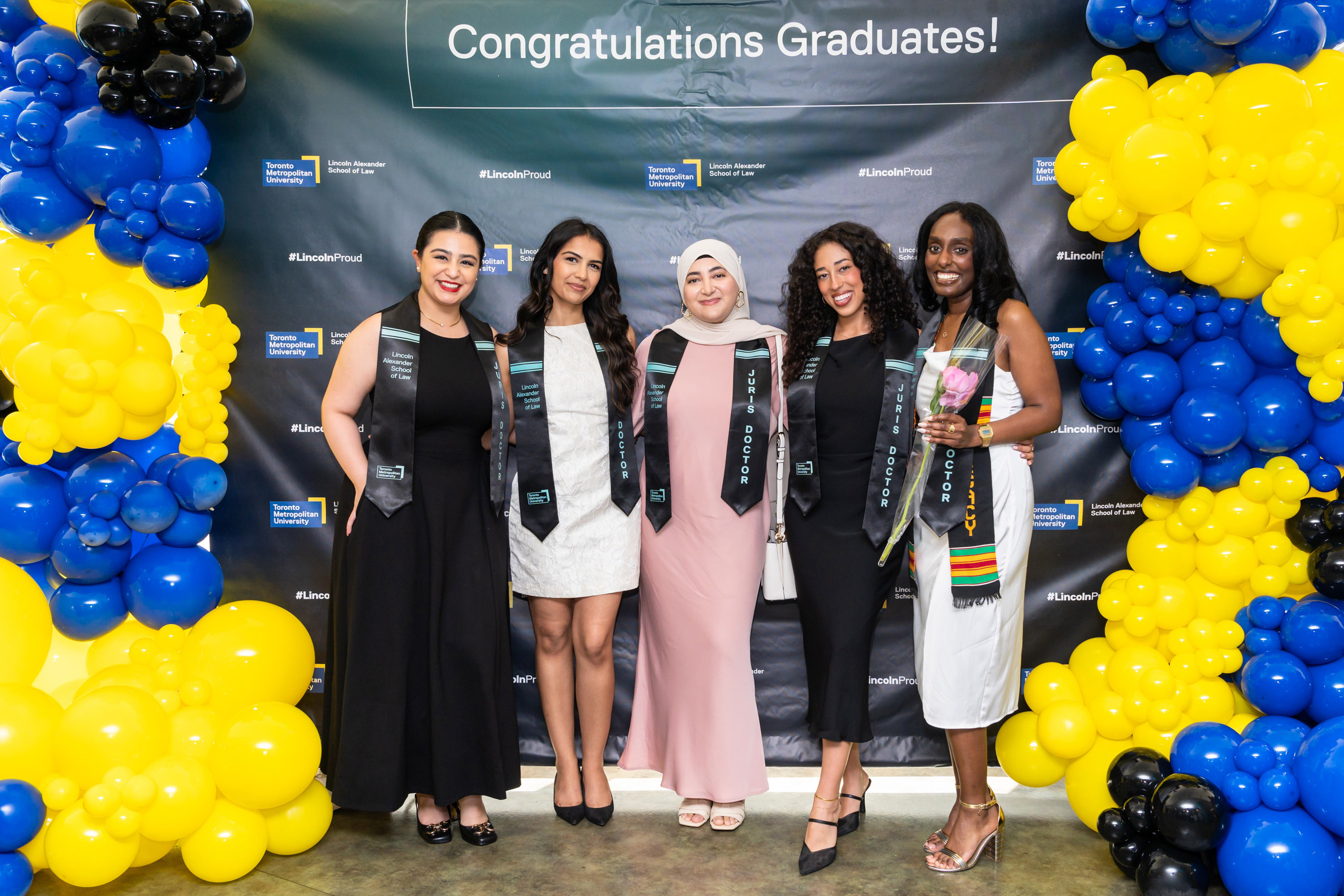 five women grads pose at the grad celebration