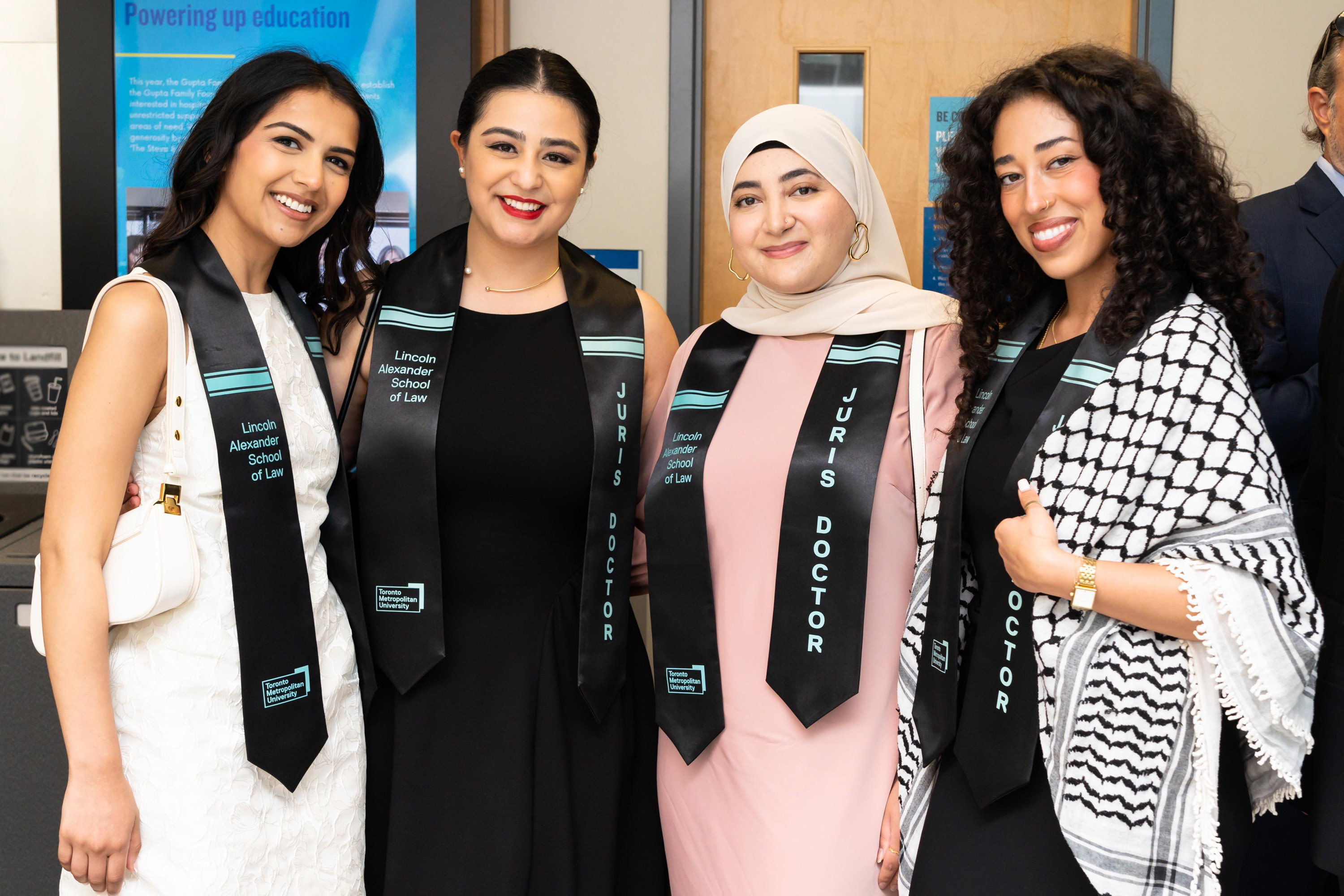 four female grads pose for photo