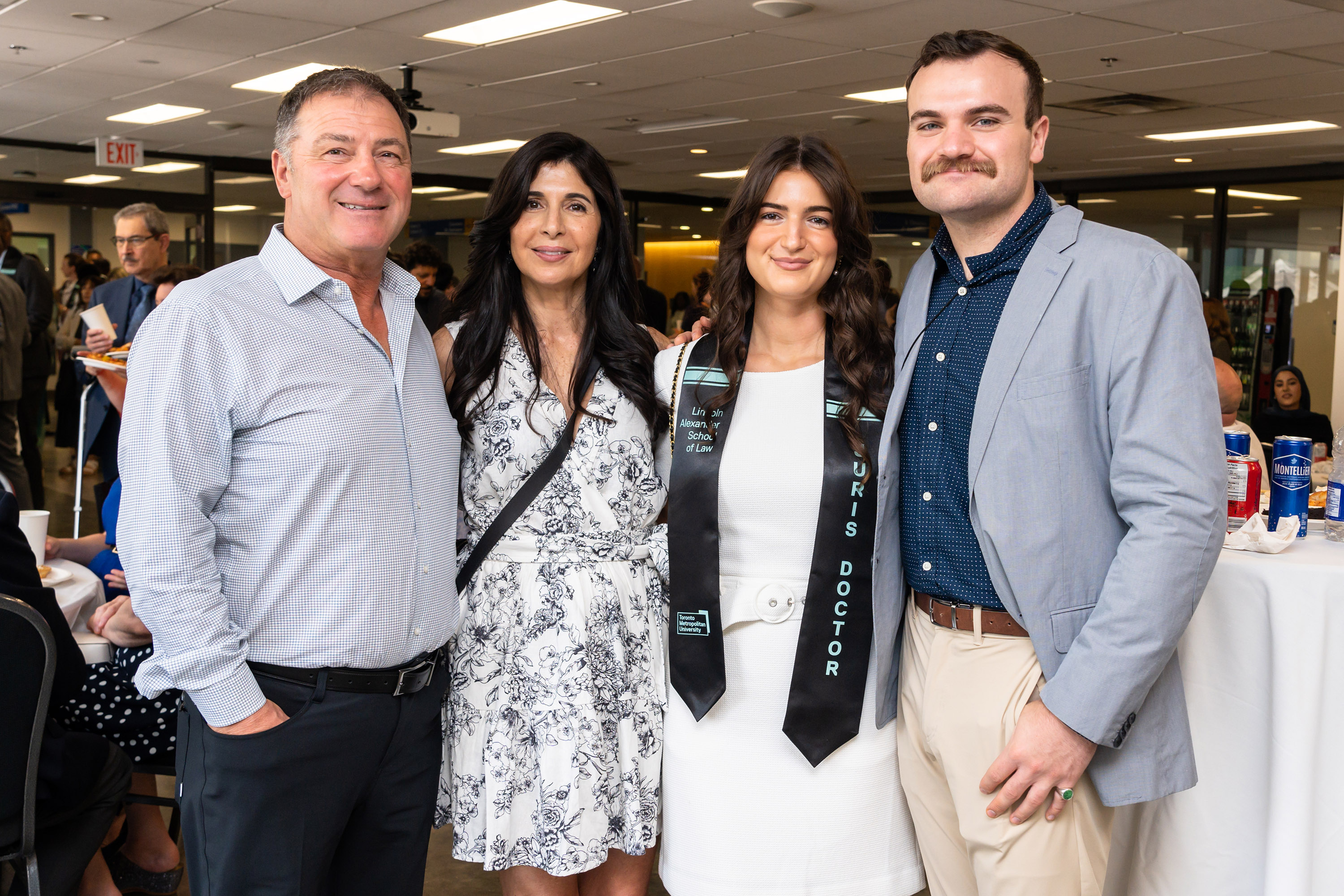 four people pose for camera at celebration lunch