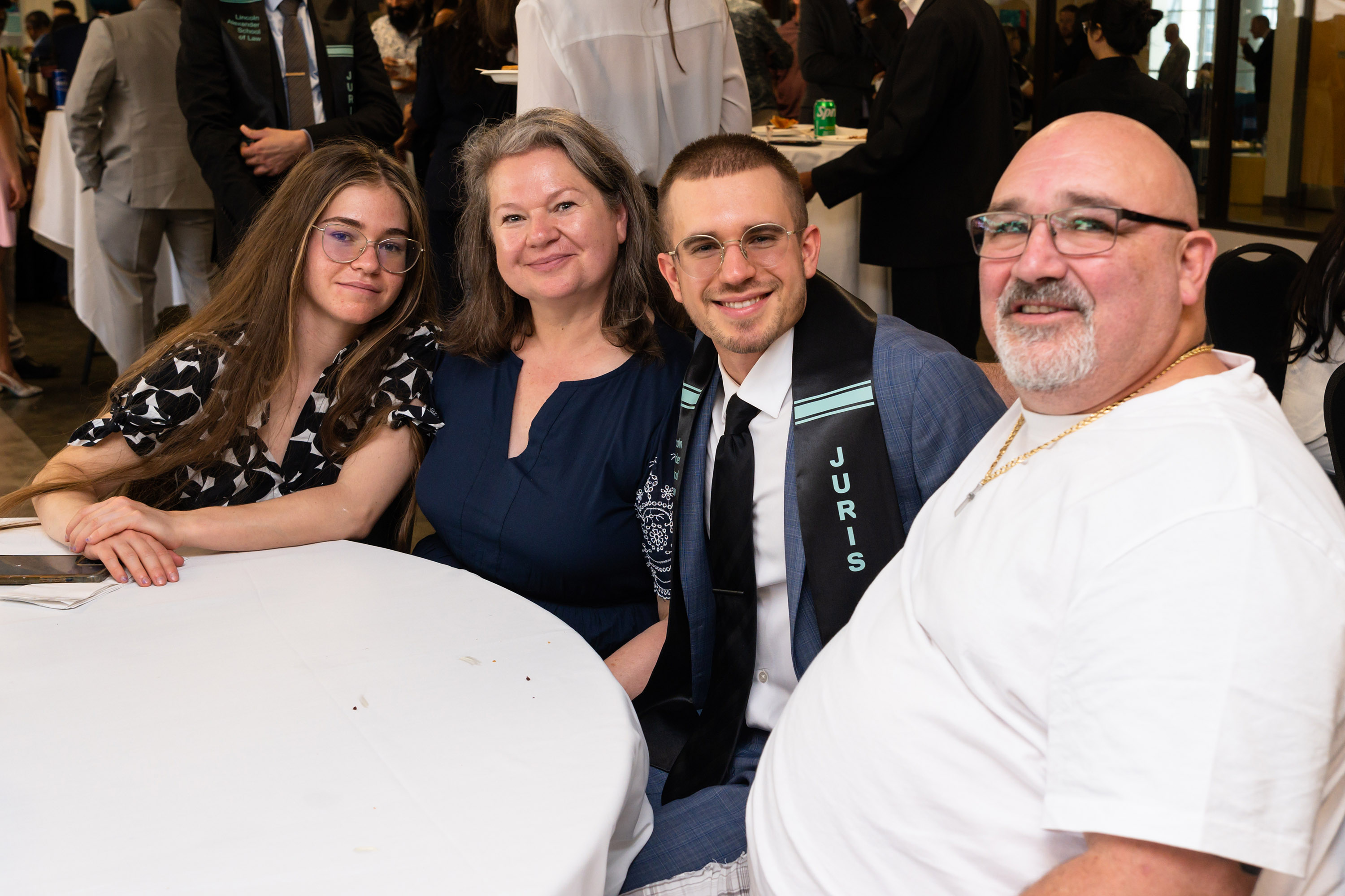 family with grad seated at table