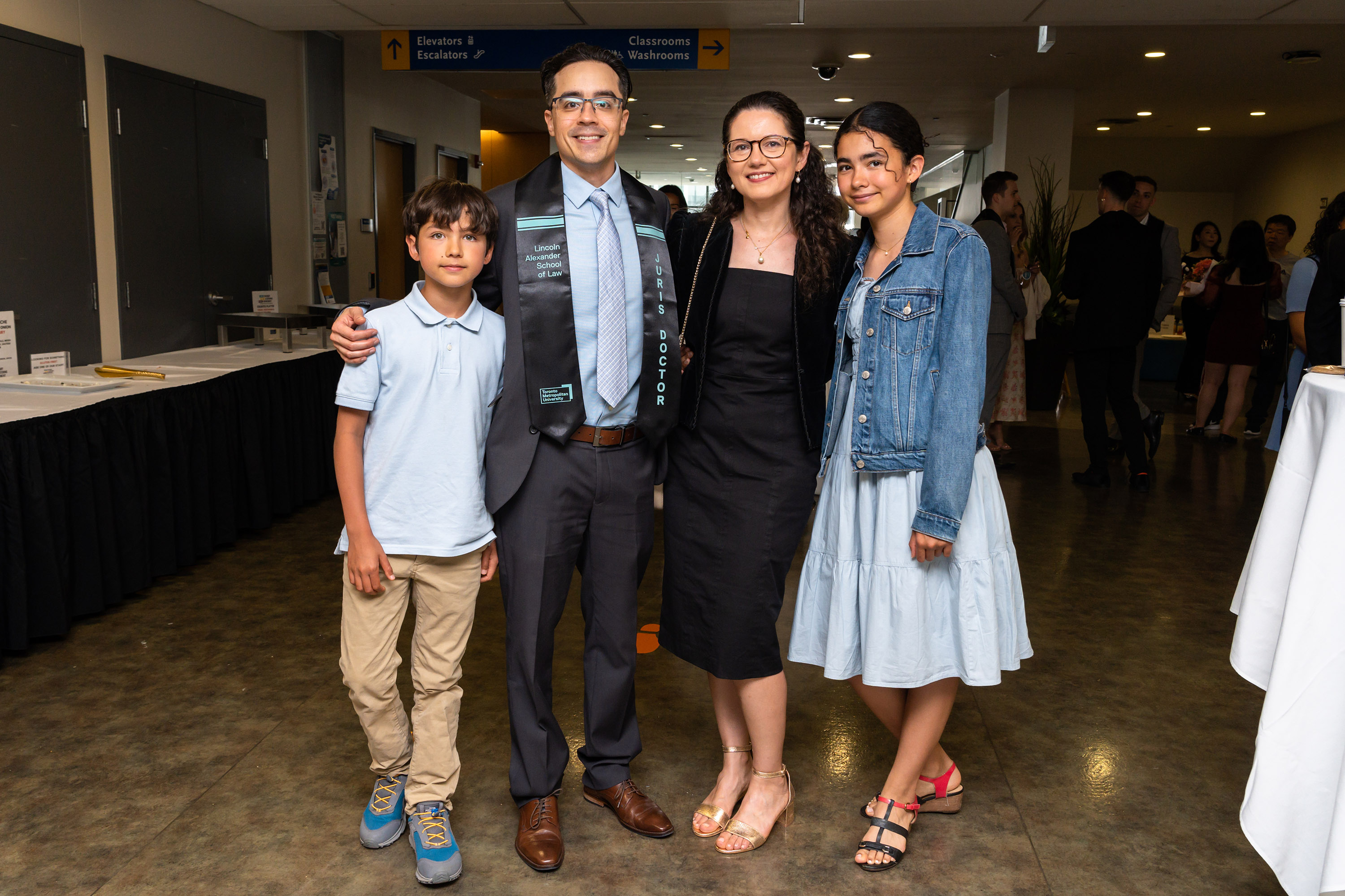 grad with family posing at celebration