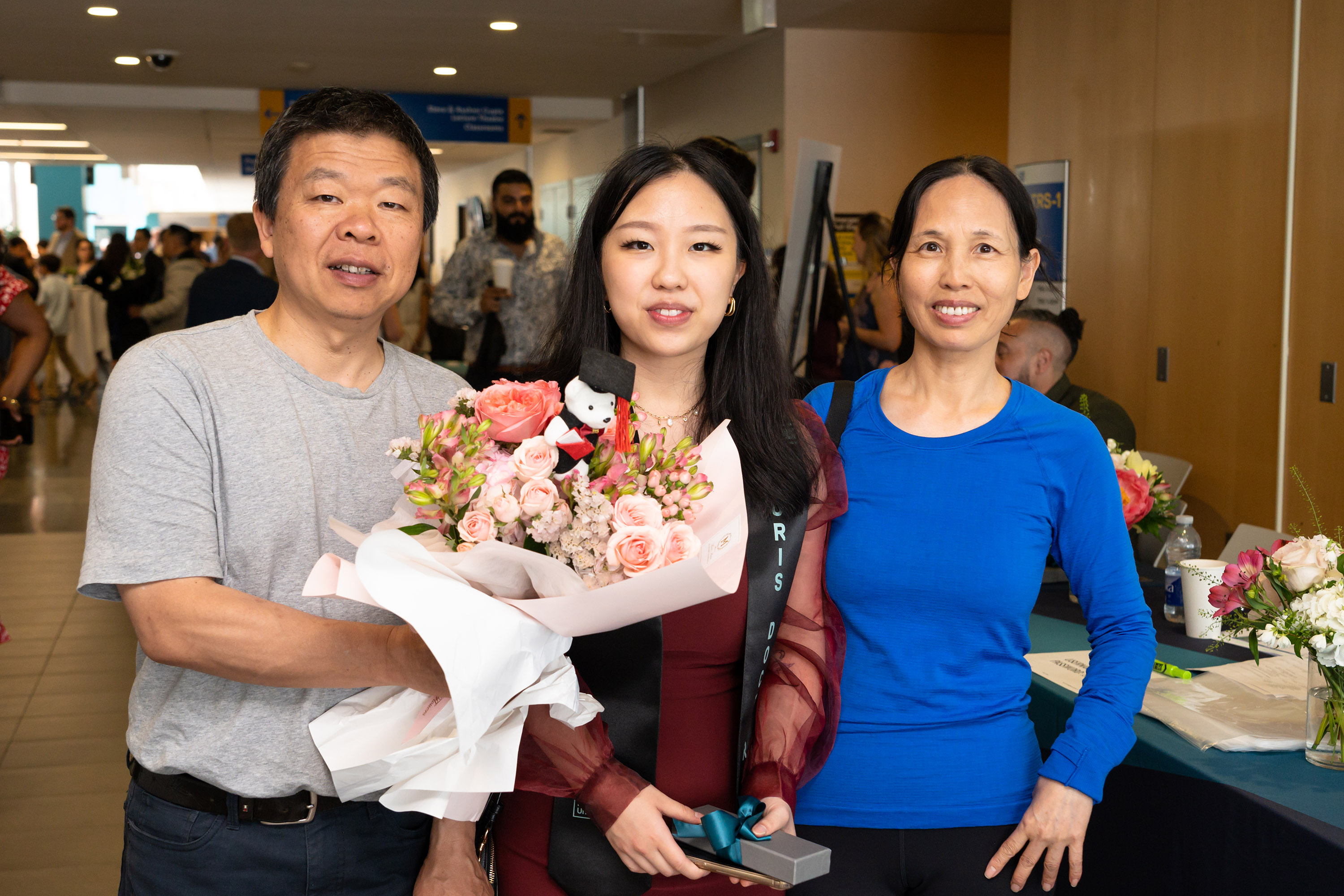 grad with parents posing