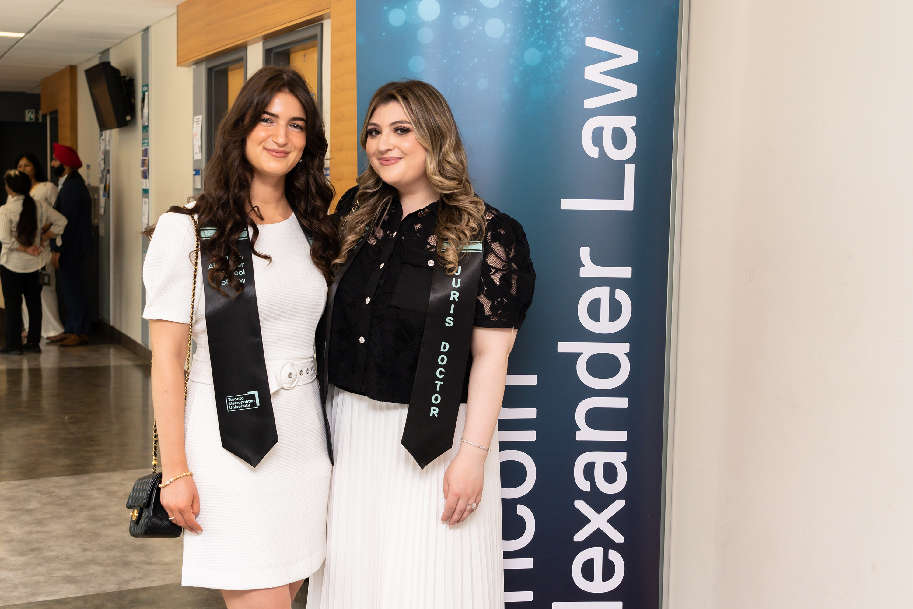 two female grads posing