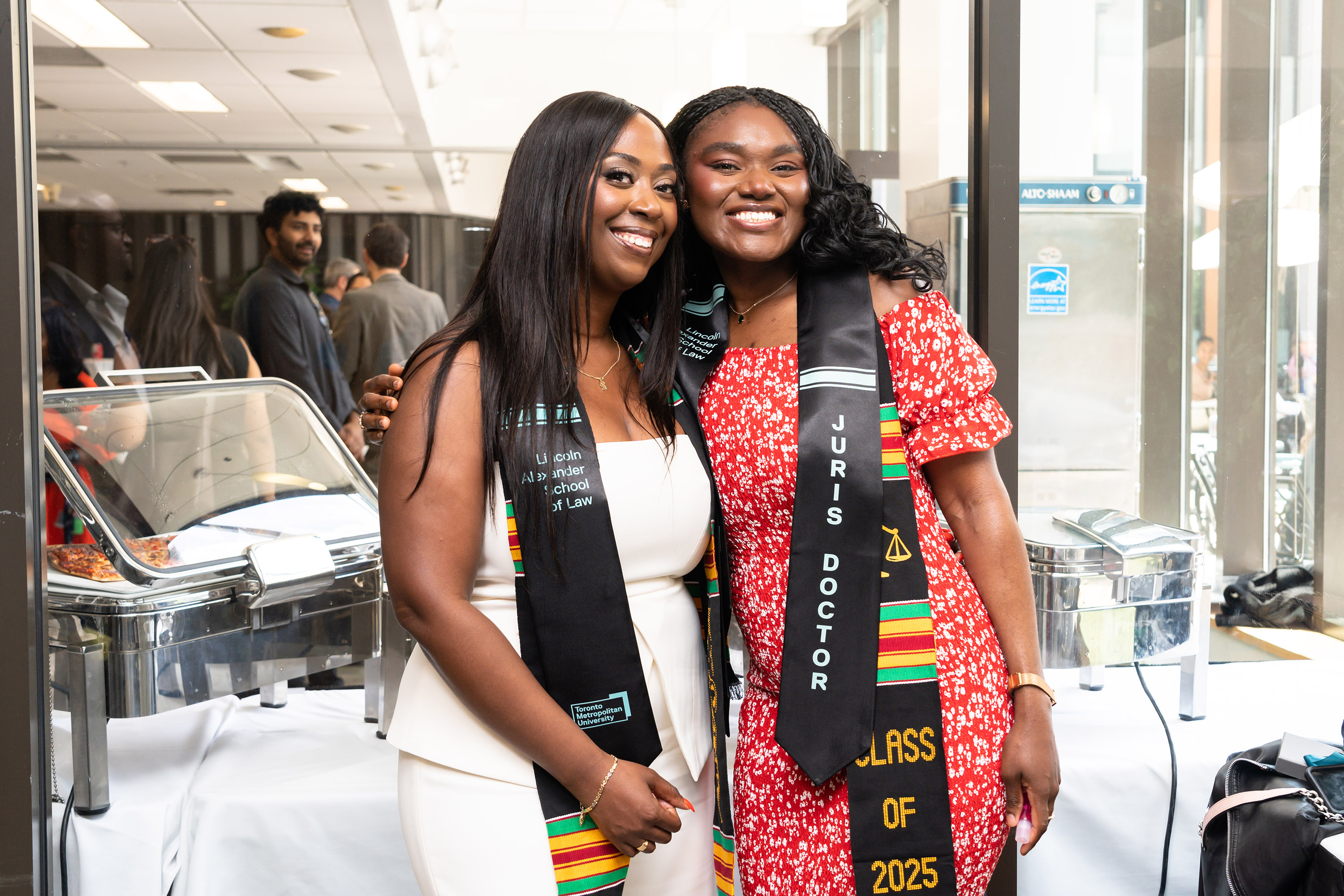 two women grads smiling for camera