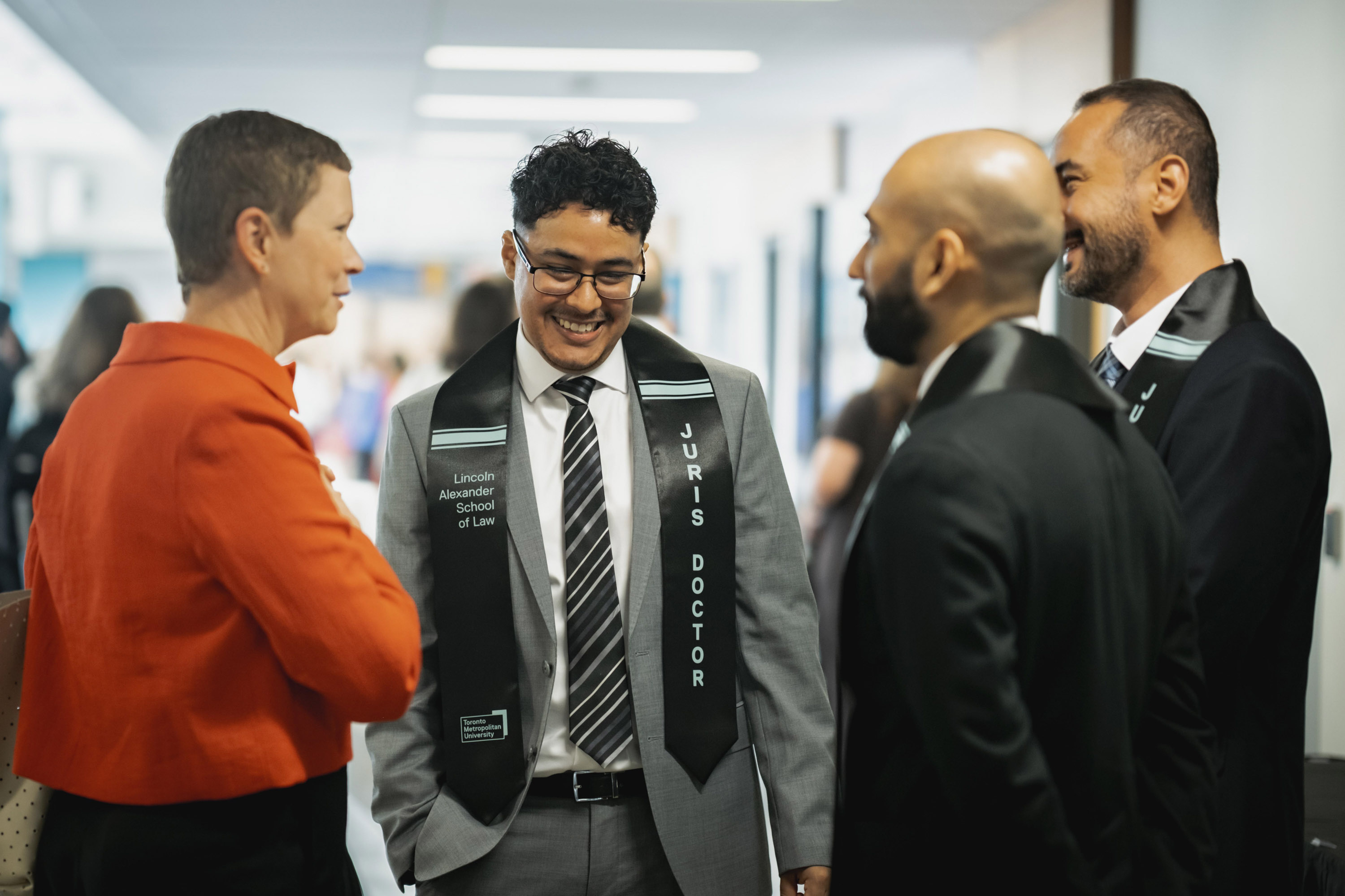 grads and faculty in discussion at celebration