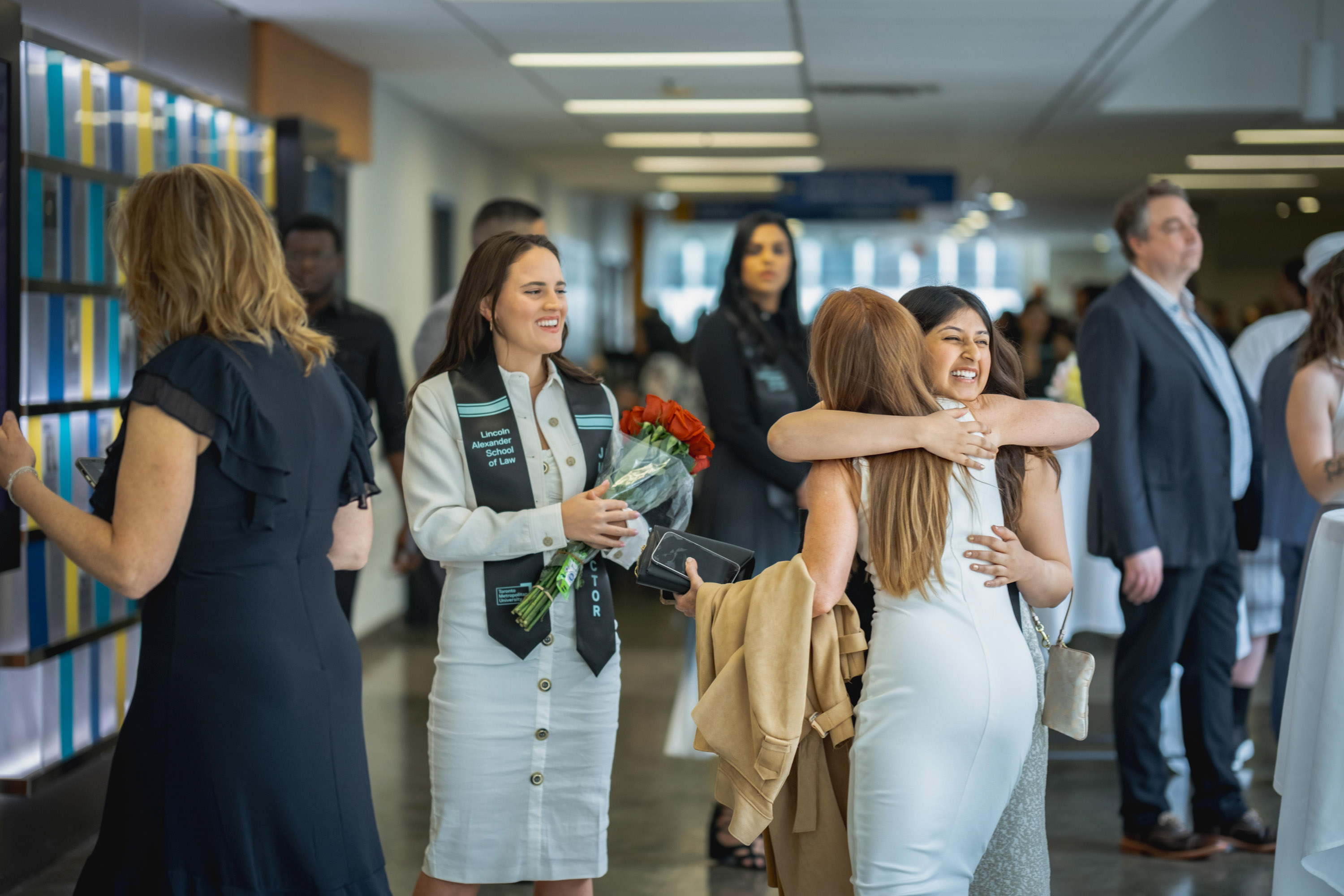 grads hugging in hallway