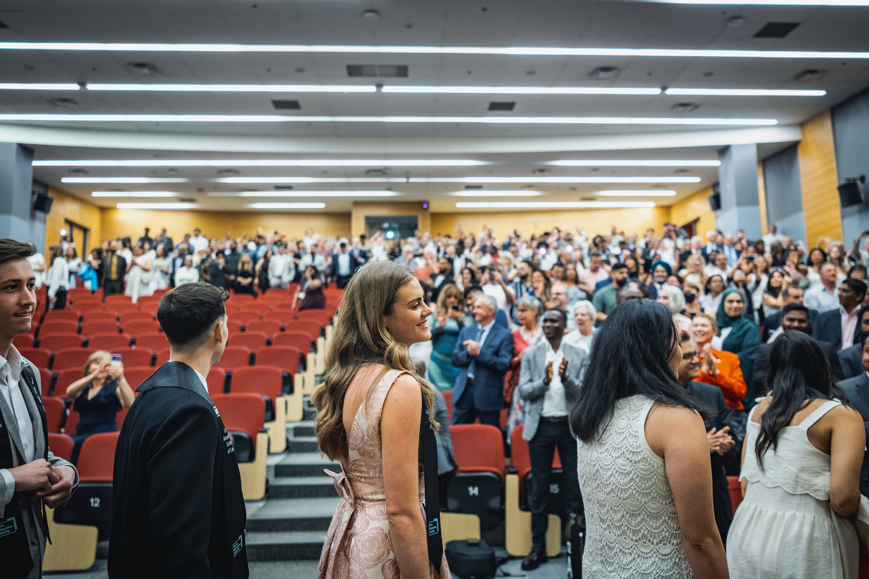 students walking leaving the auditorium