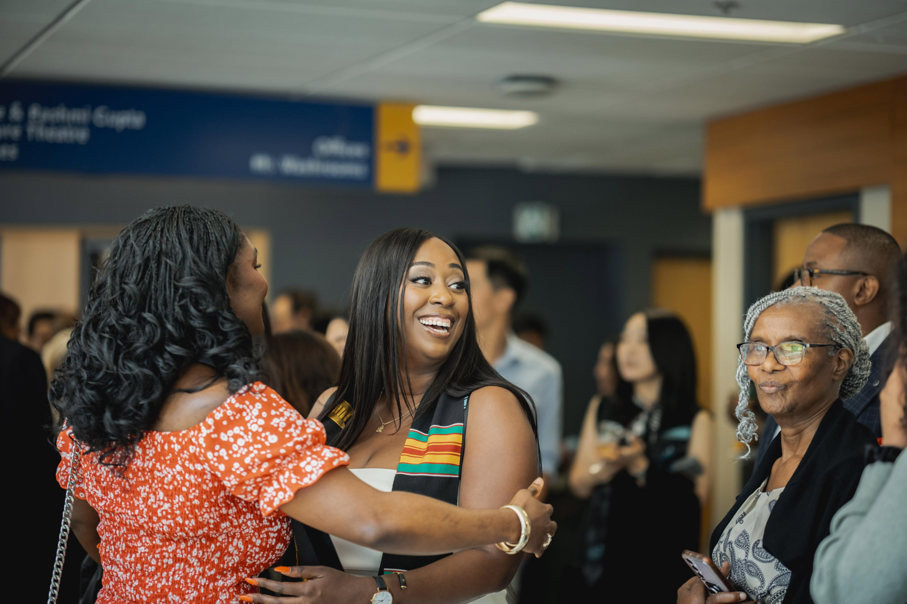 two women embrace in hallway