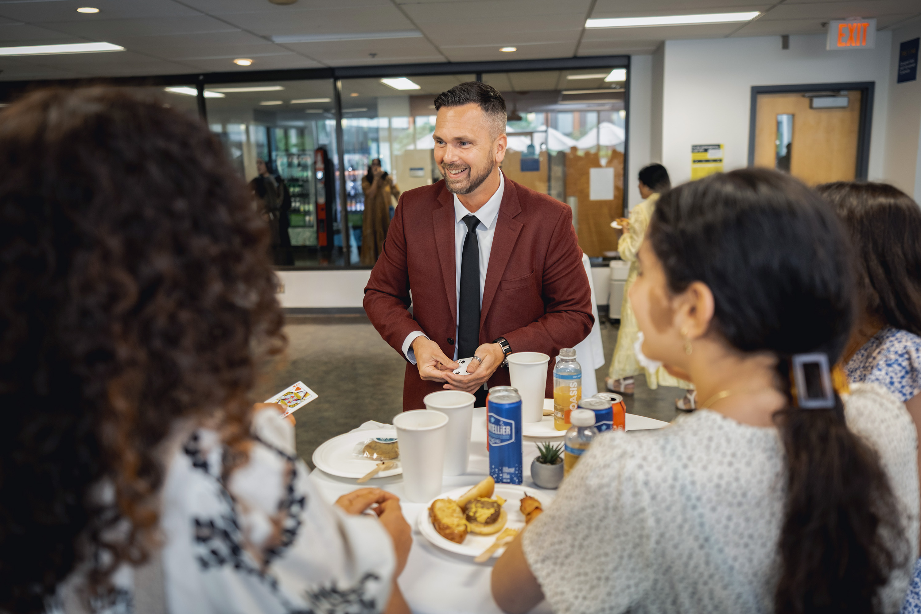 people standing around a table in conversation