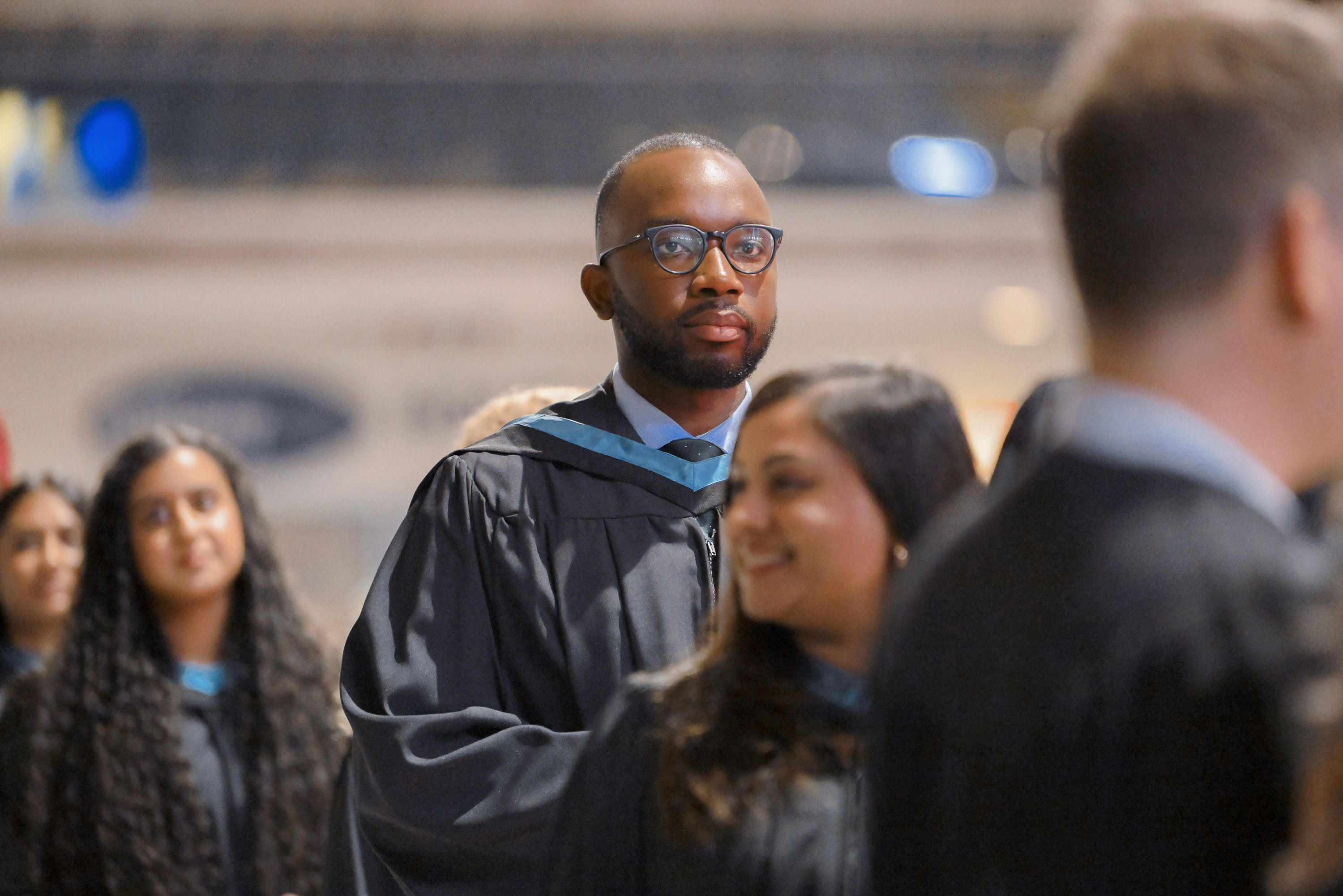 male grad walking in procession