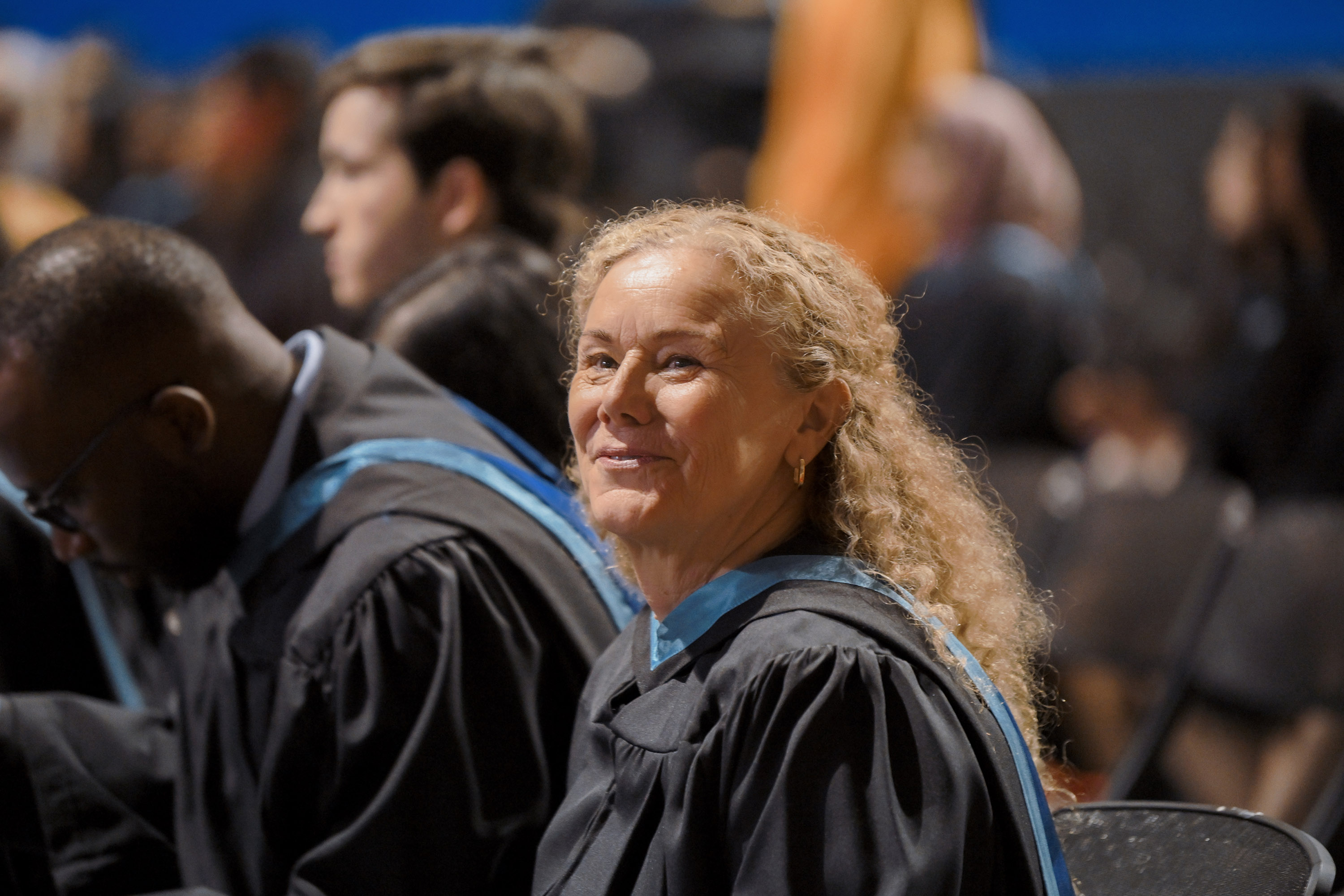 female grad smiling in the seats