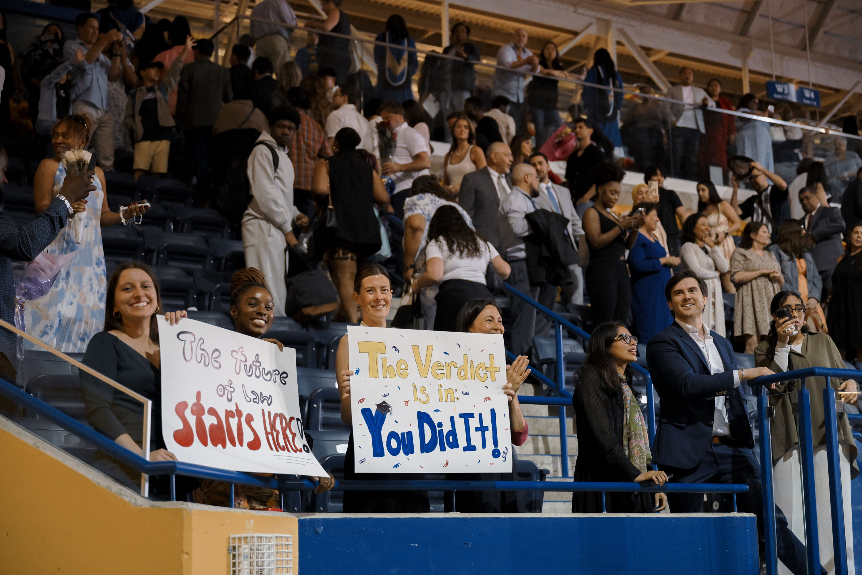 audience members holding signs the verdict is in you did it