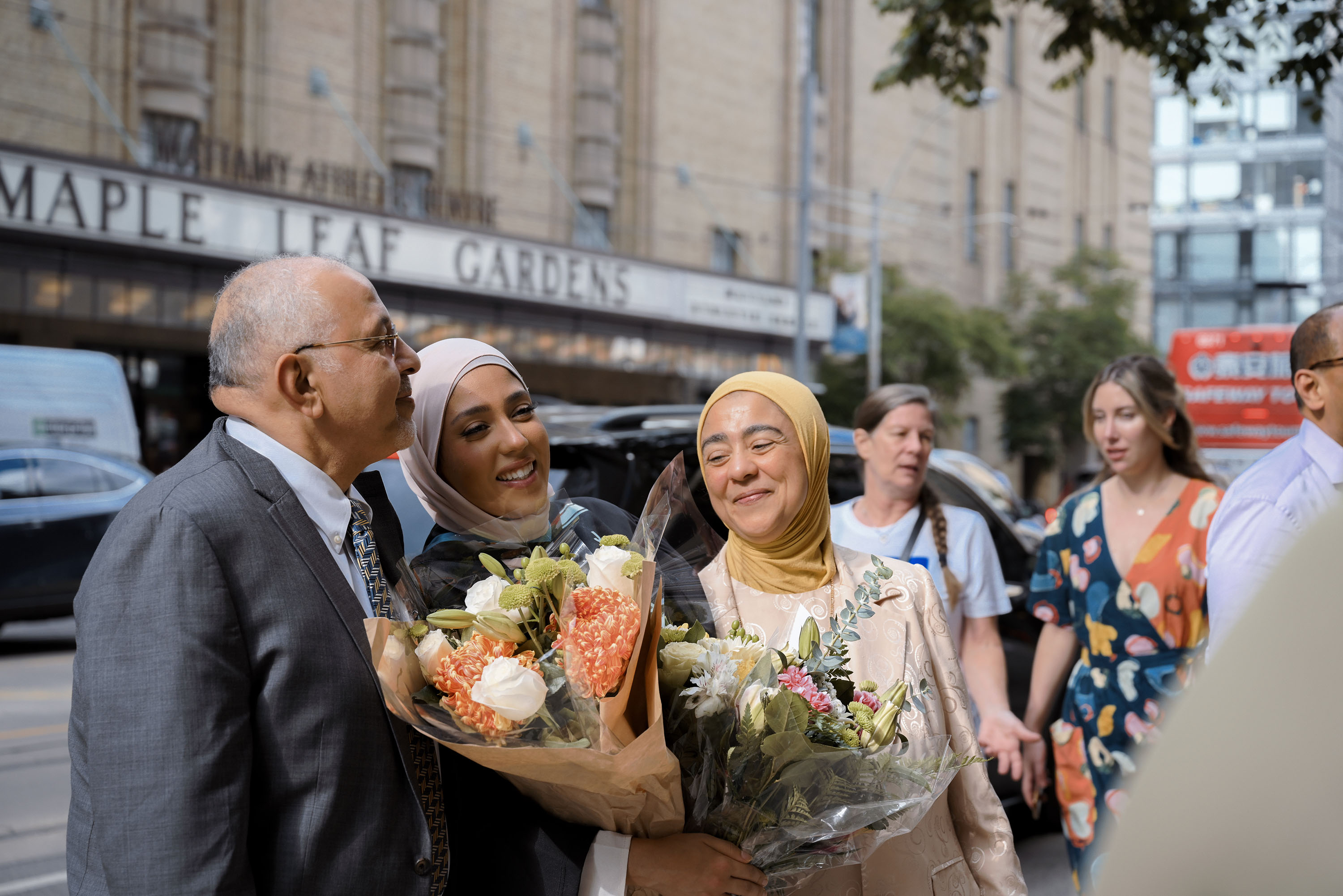 family with grad posing outside maple leaf gardens