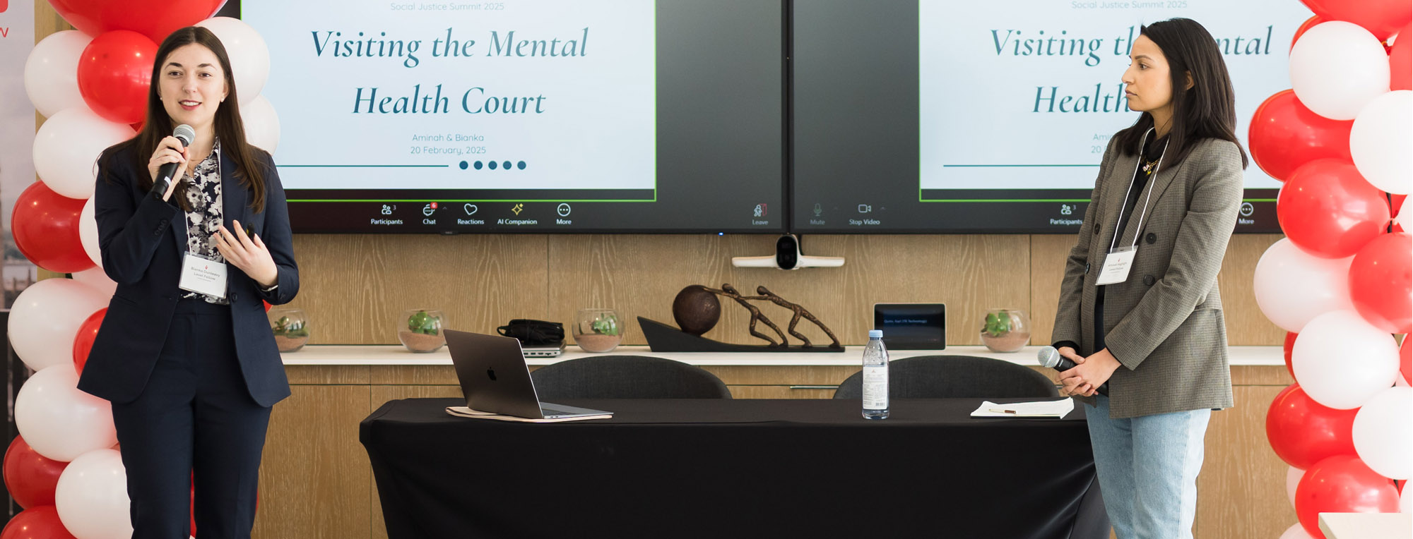 Law students Bianka Dunleavy (left) and Aminah Haghighi presented their research ideas at a Social Justice Summit last February.