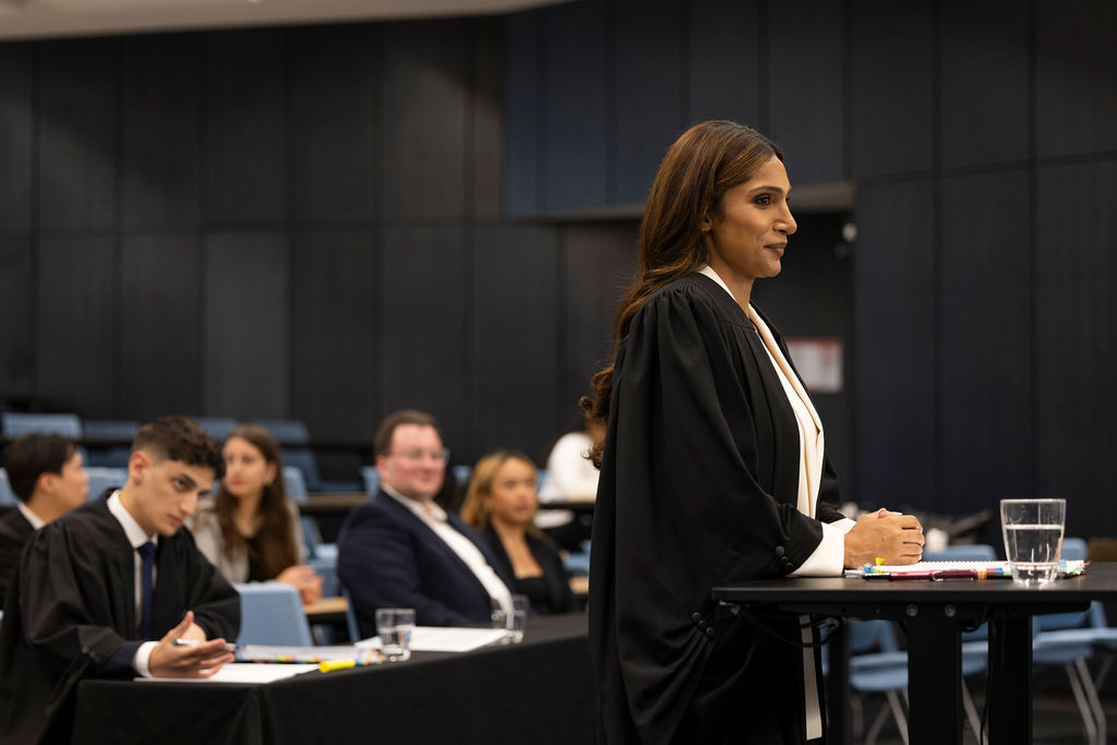 student in robe  in courtroom