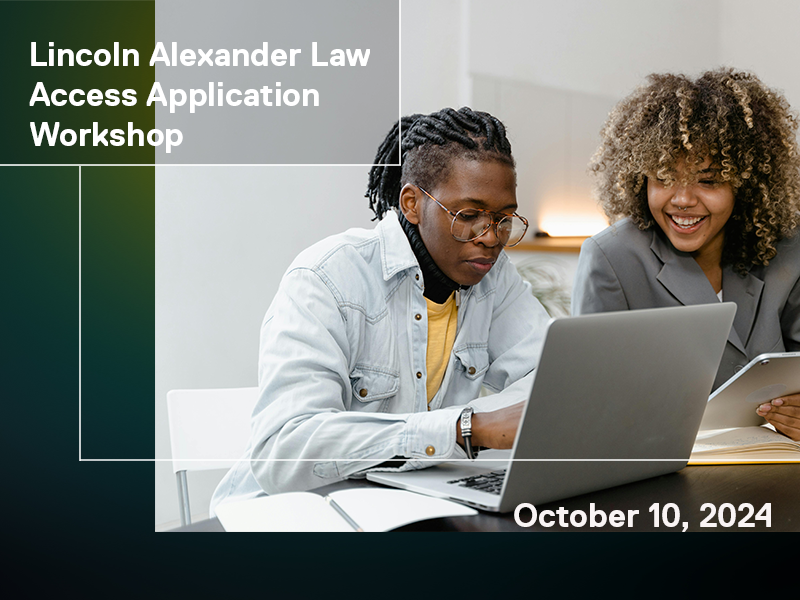 two people talking over a laptop.