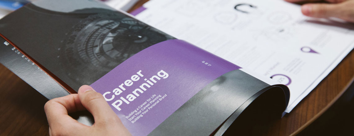 close up of hands flipping through a careers brochure