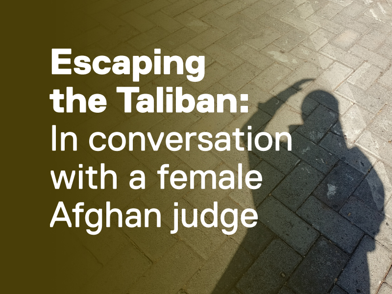 The shadow of a woman on a stone street.