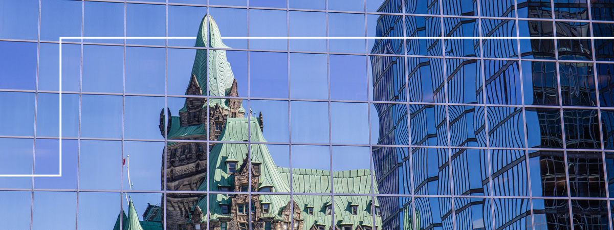 government buildings reflected in a window facade