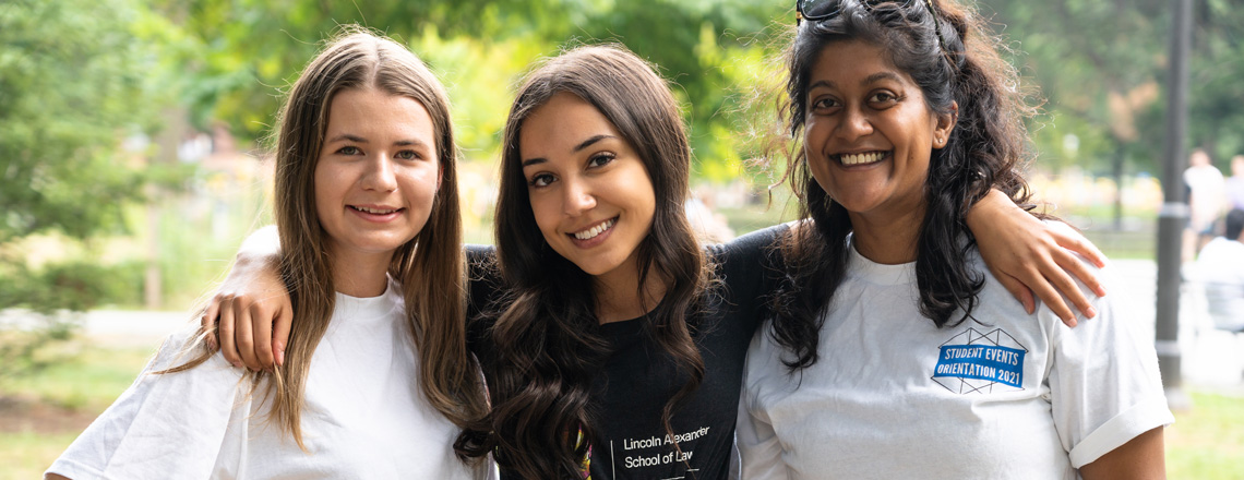 Three students smiling