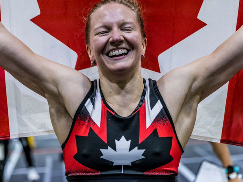 Julia Bayne celebrating win holding canadian flag