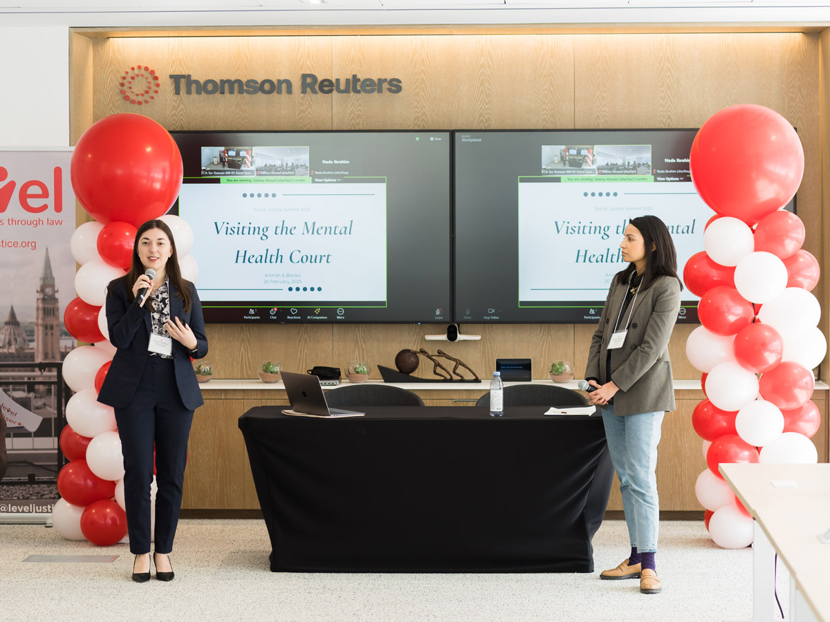 Law students Bianka Dunleavy (left) and Aminah Haghighi presented their research ideas at a Social Justice Summit last February.