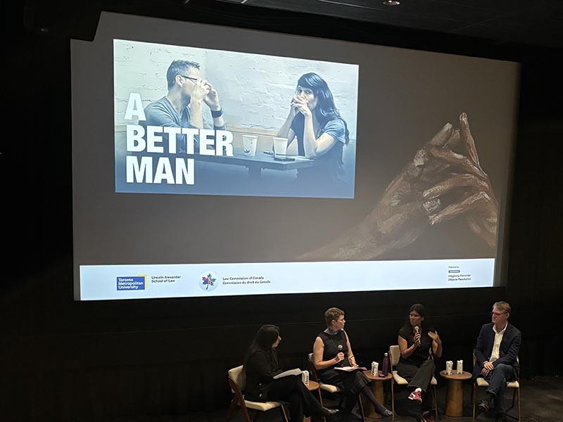 Four panelists sit on a stage beneath a screen displaying the film title "A Better Man."