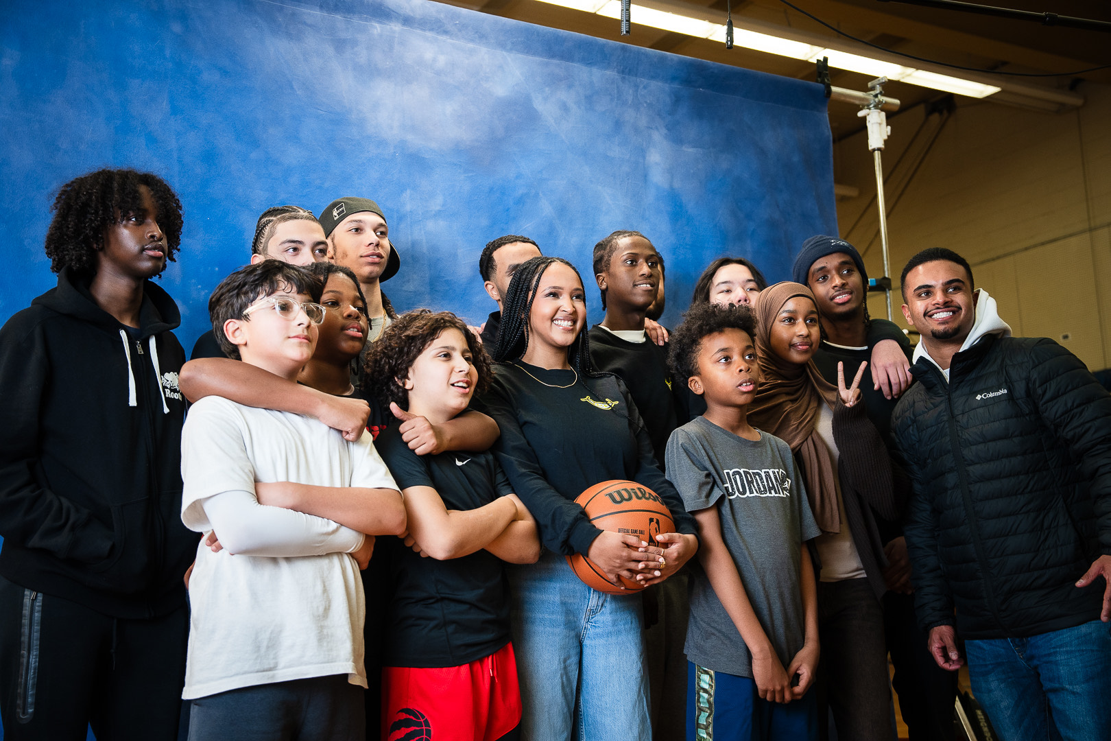 Kids smiling  in group shot at Sache Bell Raptors event