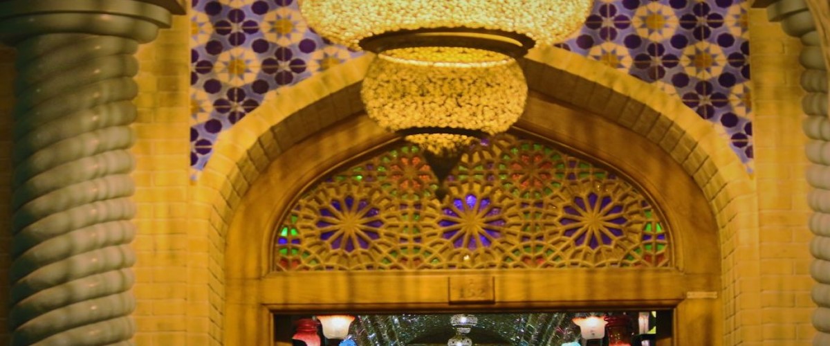 The entrance to a traditional shopping mall in Doha, Qatar showing lamps and traditional Arab architecture.