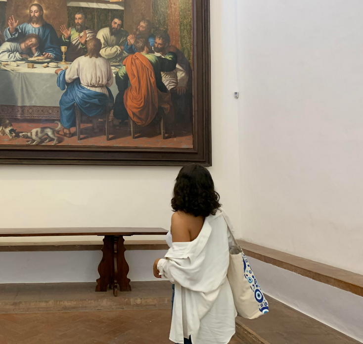 A woman looking at a painting inside a museum in Spain.