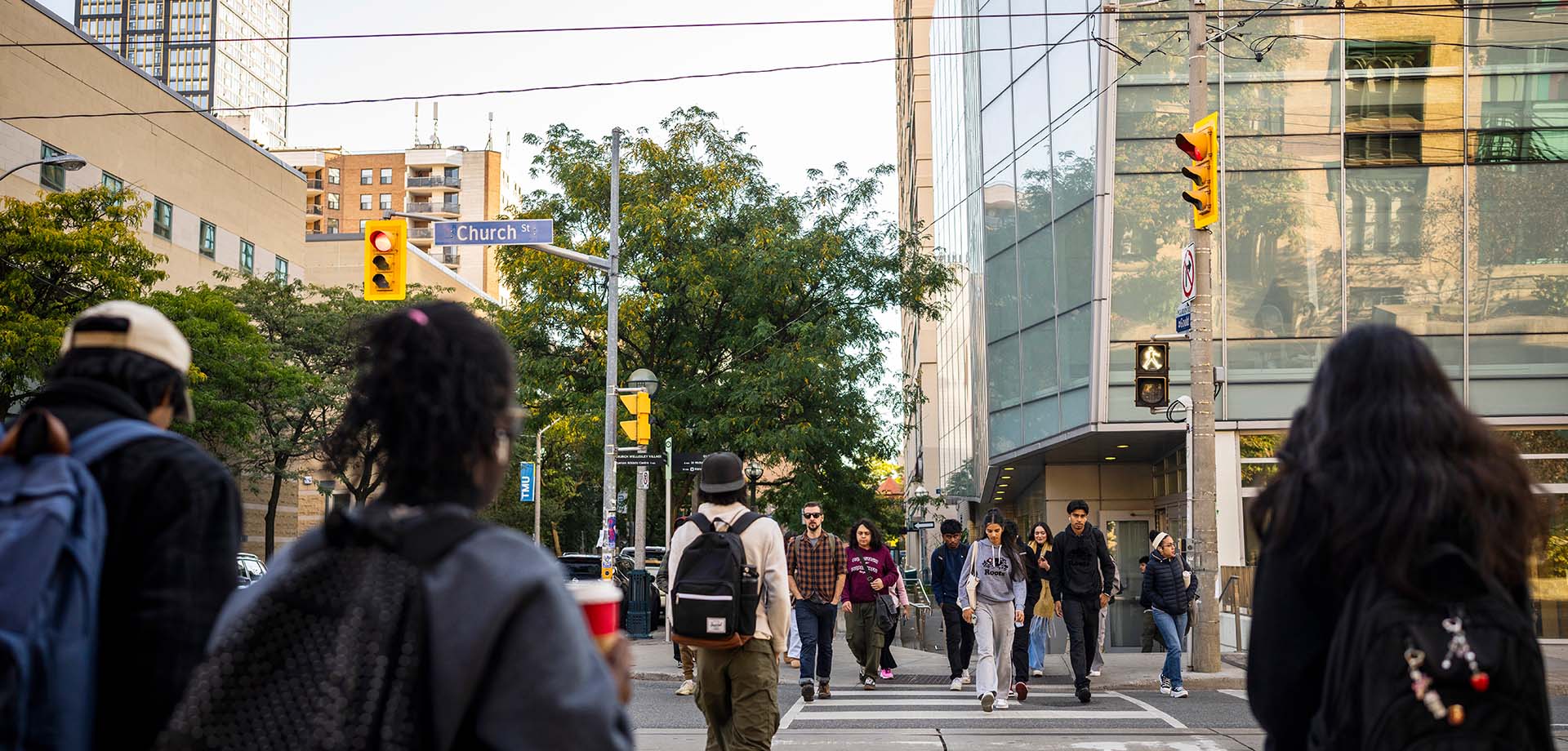Students crossing the road in front of the George Vari building