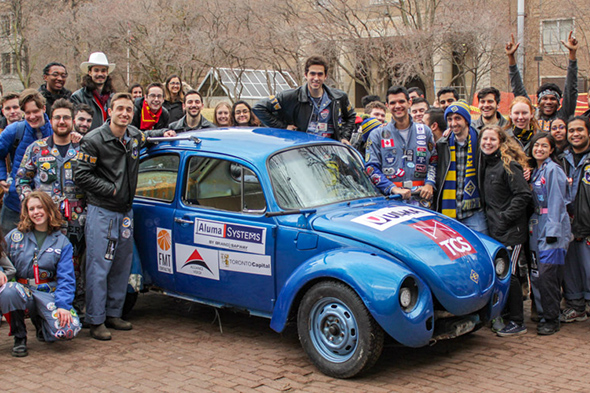 Students surround the engineering bug in the quad